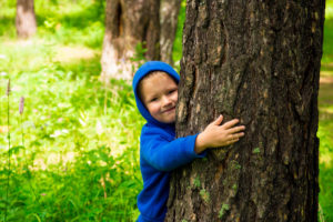 Child hugging pine (tree)