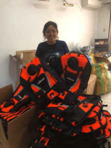 Volunteer holding 50 fire protection vests